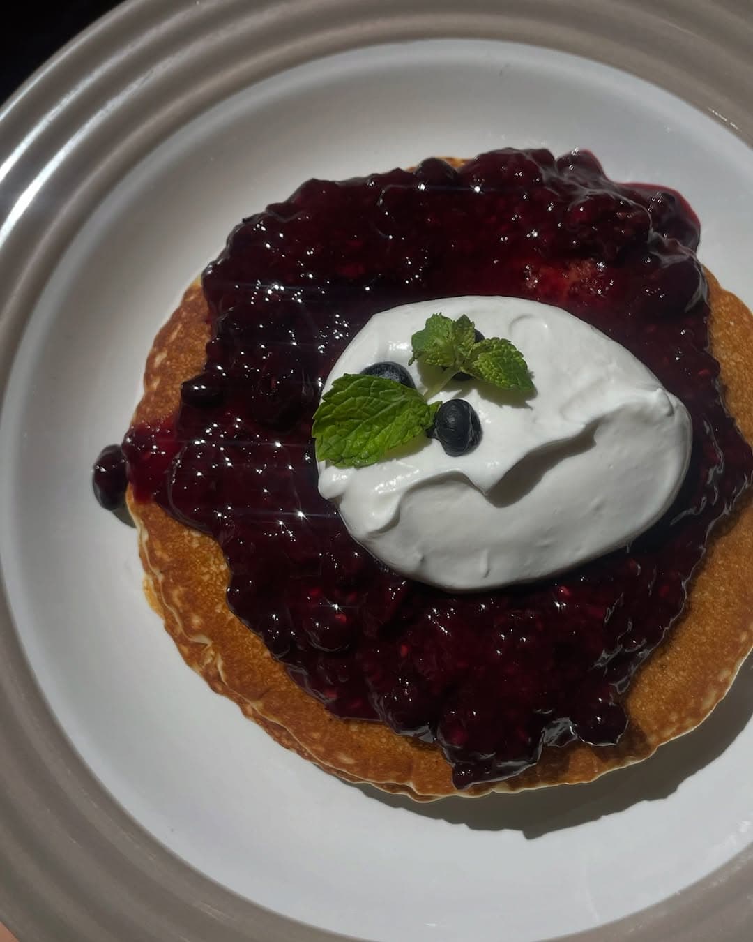 Pancakes with blueberry compote and whipped cream